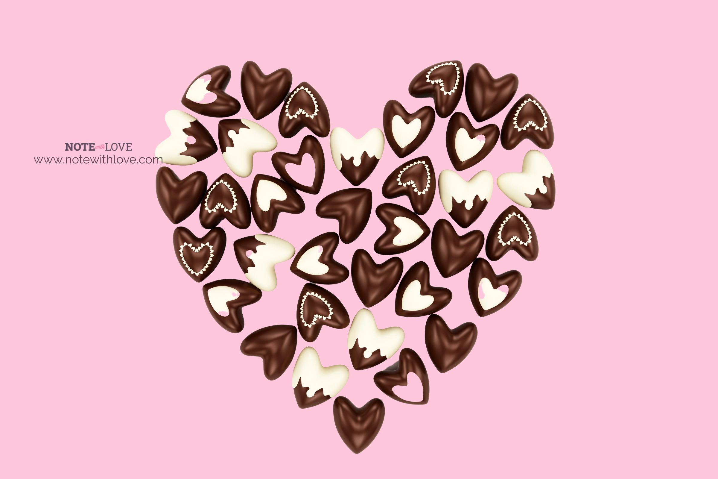 Heart shape made of small heart chocolates on a pink background