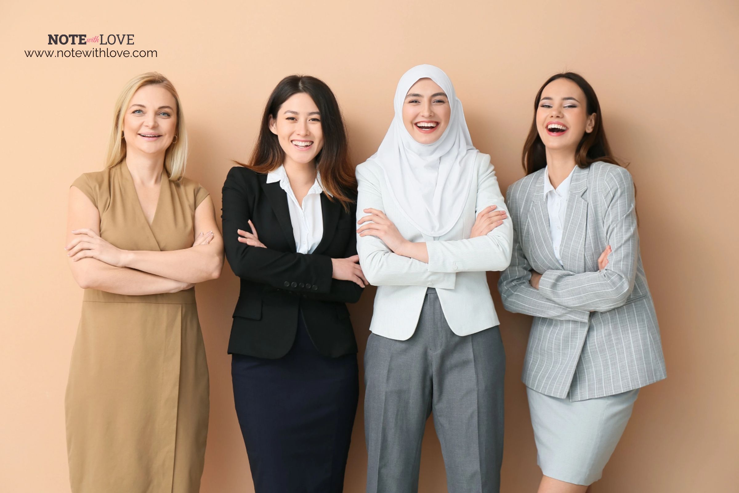 Women from different race, religion and background standing and laughing together